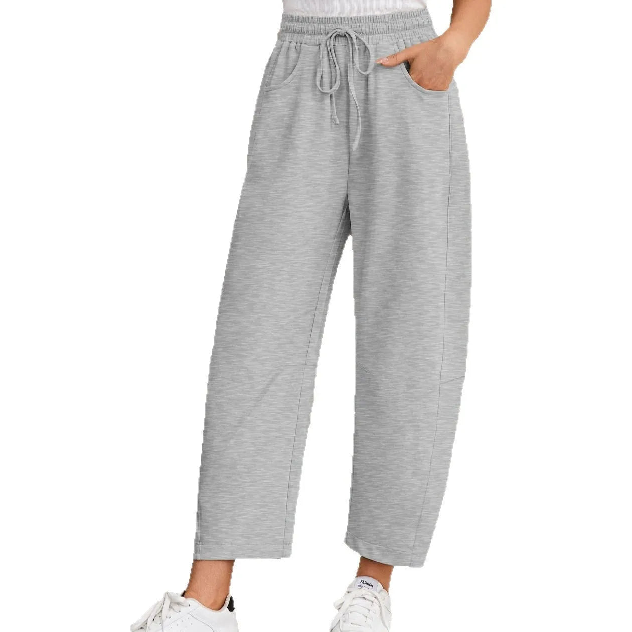 Women's loose grey cropped sweatpants with drawstring waist and side pockets on a hanger.
