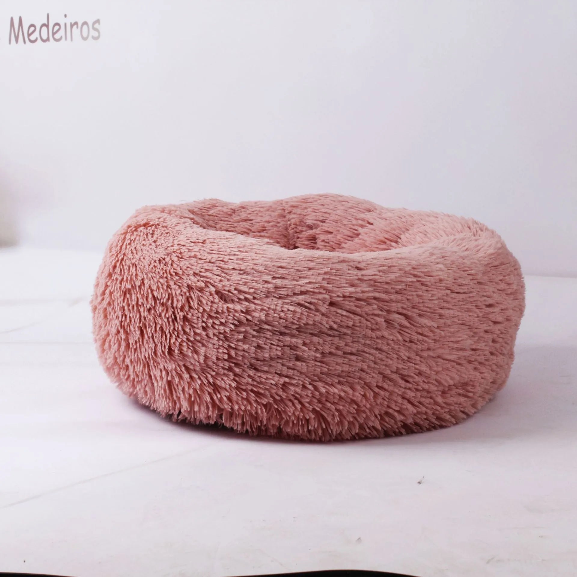 Plush pet nest in apricot colour on floor, soft cloth circular dog bed 40cm diameter indoor use