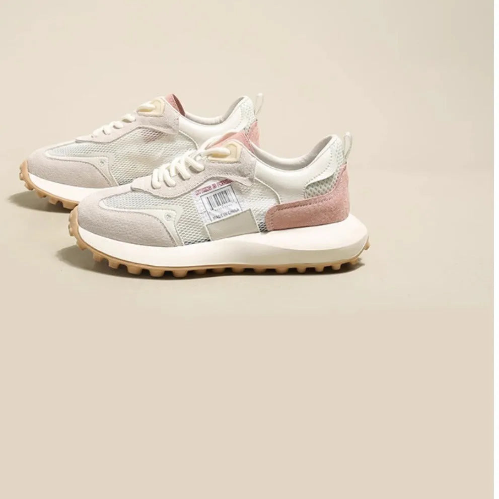 Grey and pink women's low-top retro sneakers with round toe and shallow mouth on a rubber sole.