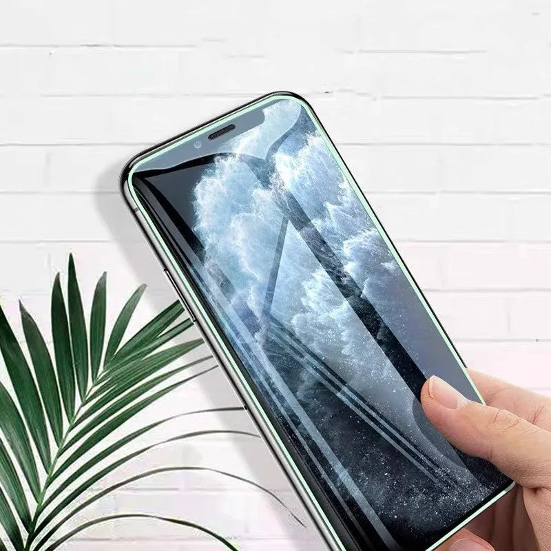 Luminous full cover tempered glass screen protector glowing on an iPhone in a dark setting.