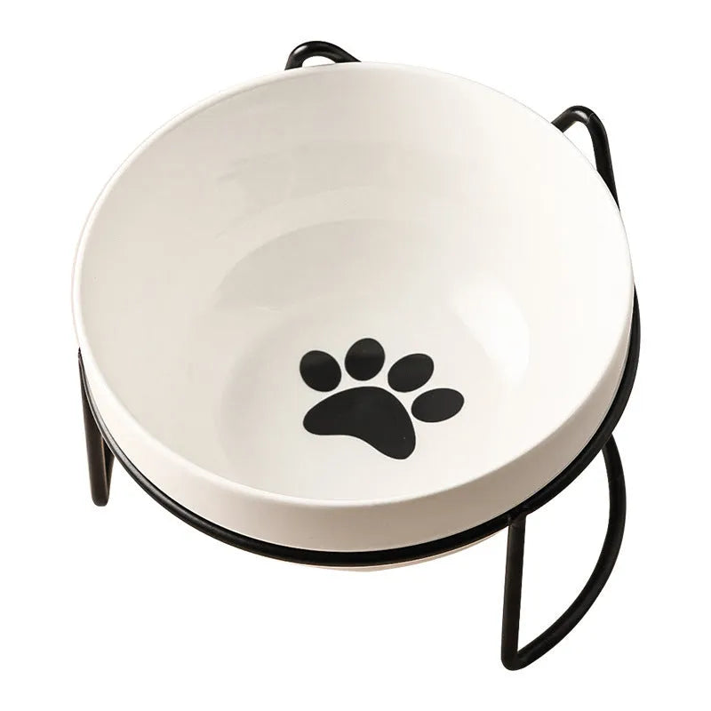 Ceramic cat bowl with iron frame stand showing cat paw print pattern and gold metal finish