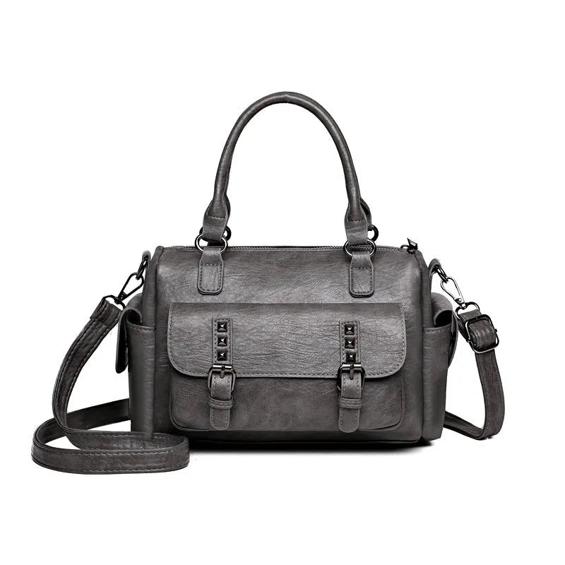 Vintage messenger bag in horizontal square shape showing contrast stitching details and shoulder strap