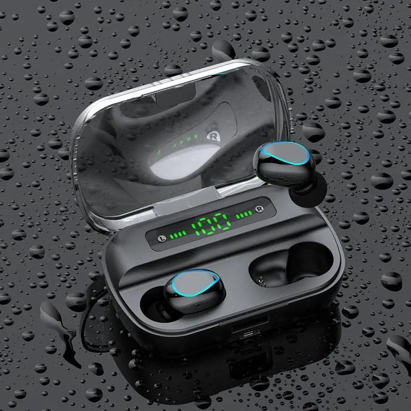 Wireless Bluetooth headset in black with earbuds and charging cable on a desk