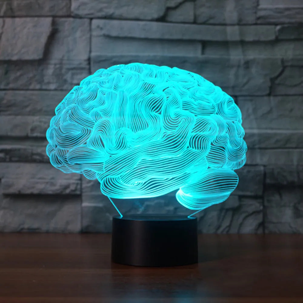 3D acrylic brain illusion LED desk lamp with remote control on a wooden table.