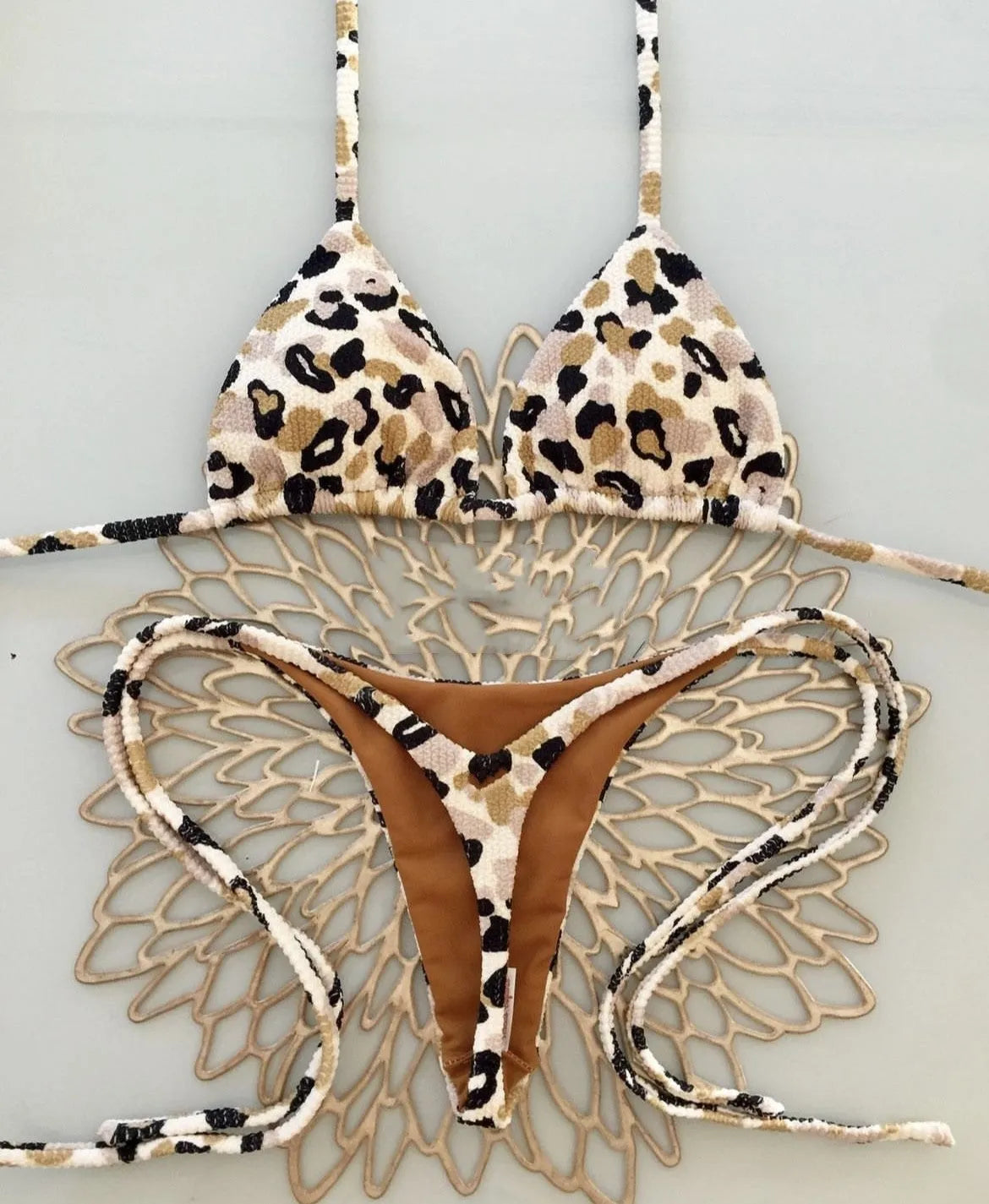 Women's bikini swimsuit with printed fabric in briefs style, showing high elasticity and cotton lining