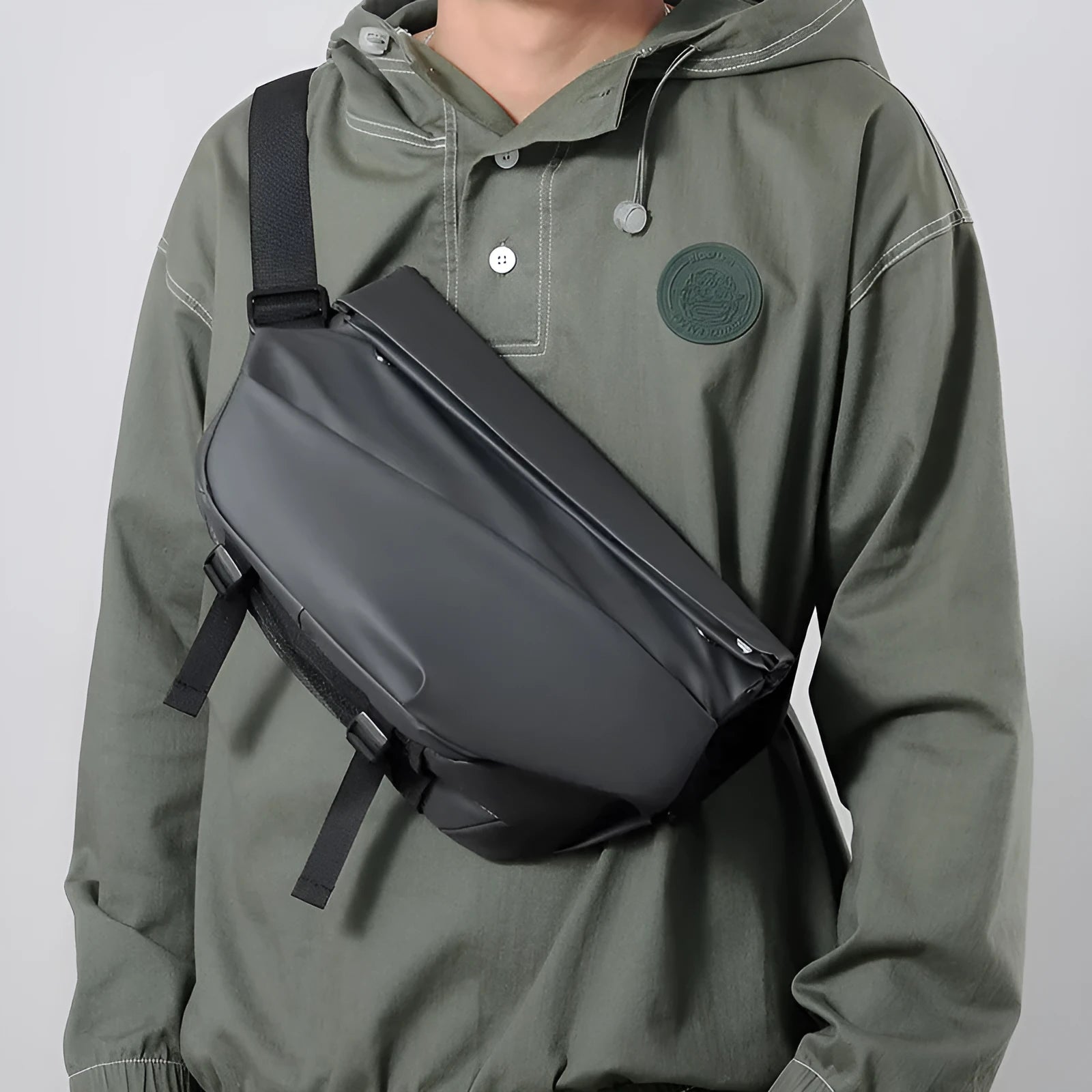 Grey PU crossbody bag showing front zipper compartment and adjustable shoulder strap