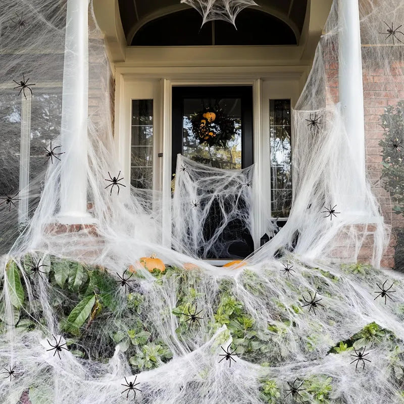 White cotton spider web Halloween decoration with plastic spiders for party or haunted house atmosphere