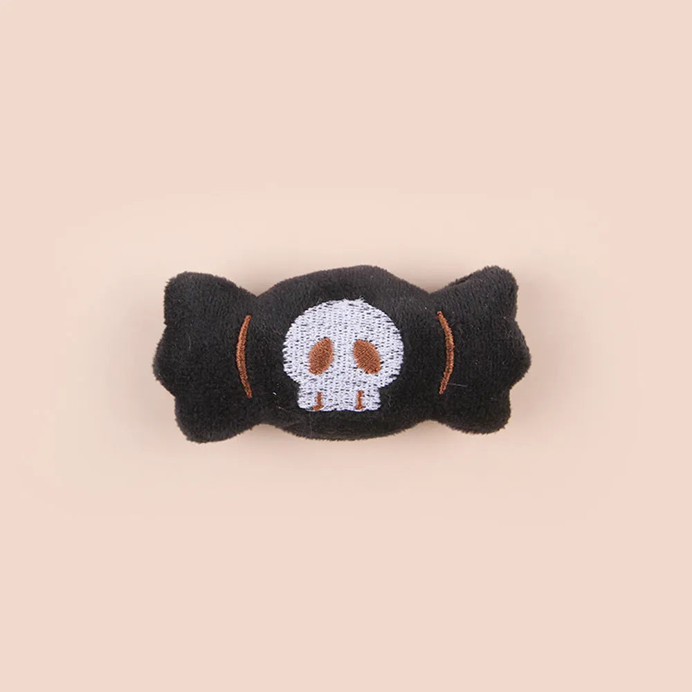 Plush cat wand toy with 27cm handle showing three interchangeable colourful heads: eyes, candy, and skull designs