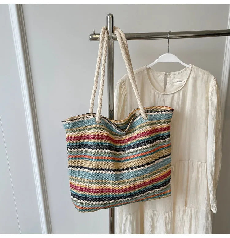 Blue straw-woven nylon shoulder bag with large main compartment and single strap