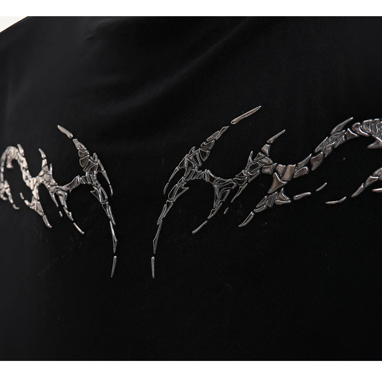 Men's black slim-fit mesh long-sleeve bottoming shirt laid flat, showing texture.