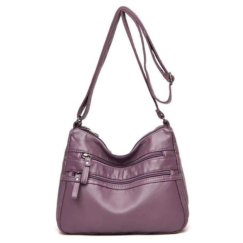 Women's washed leather crossbody bag in solid colour, retro messenger style with adjustable strap and soft handle
