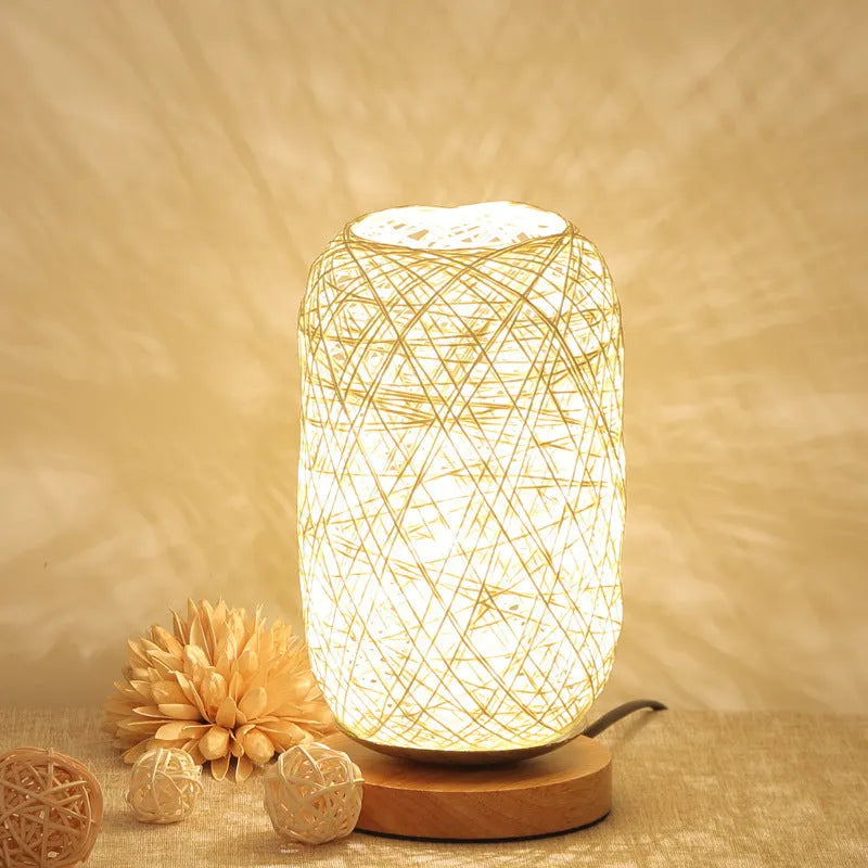 Brown hemp rope Sepak Takraw ball desk lamp on a wooden base with USB cable.