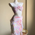 Women's floral split skirt-style swimsuit bikini three-piece set in pink with top, skirt, and panties