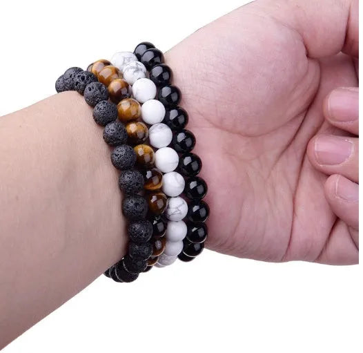 Geometric black onyx bracelet with 8mm beads on a black elastic cord.