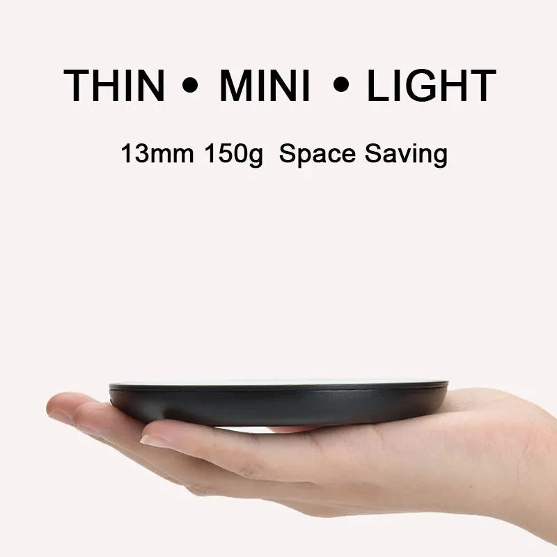 Black coffee cup warmer plate with temperature switch on desk next to mug