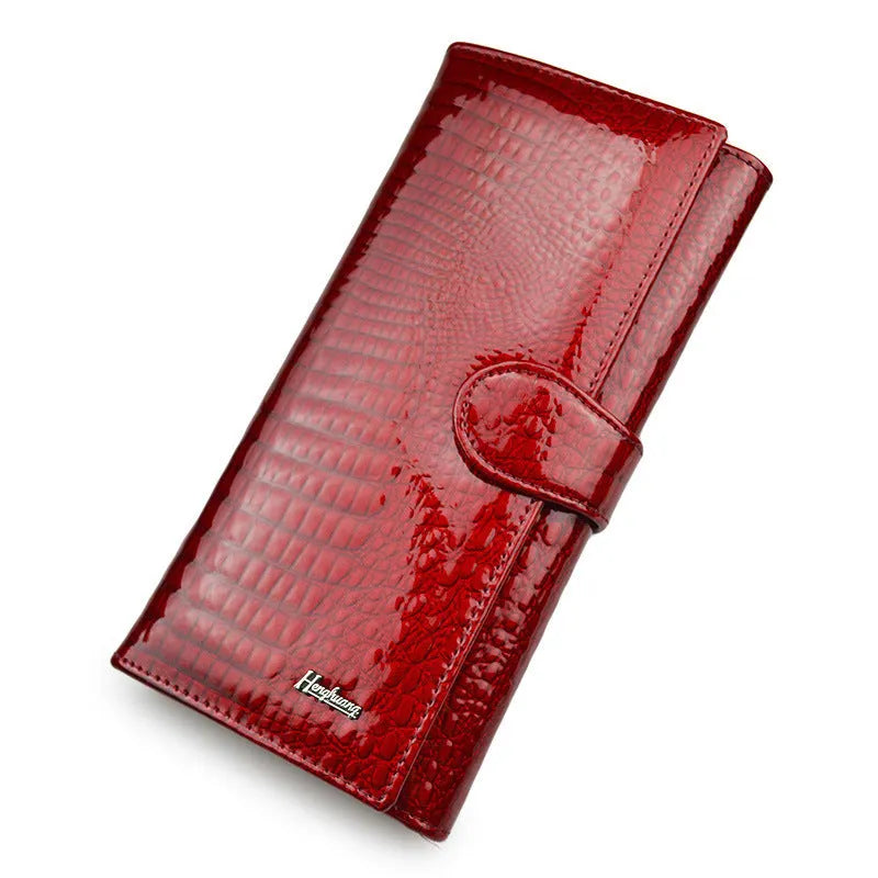 Women's red patent leather coin purse with crocodile pattern texture.