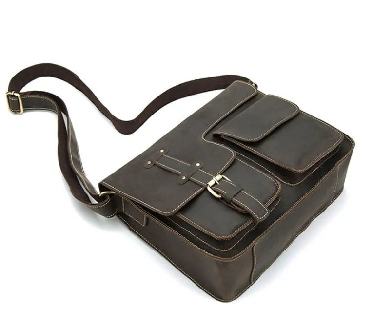 Brown leather vintage messenger bag with crossbody strap open showing laptop compartment