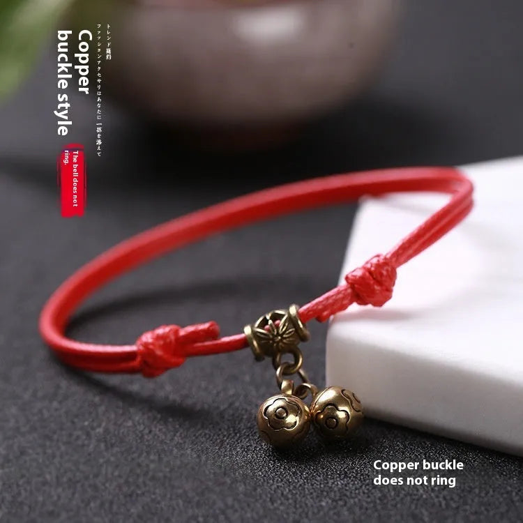 Small dog wearing adjustable nylon rope collar with brass bell in black, red, or coffee colour