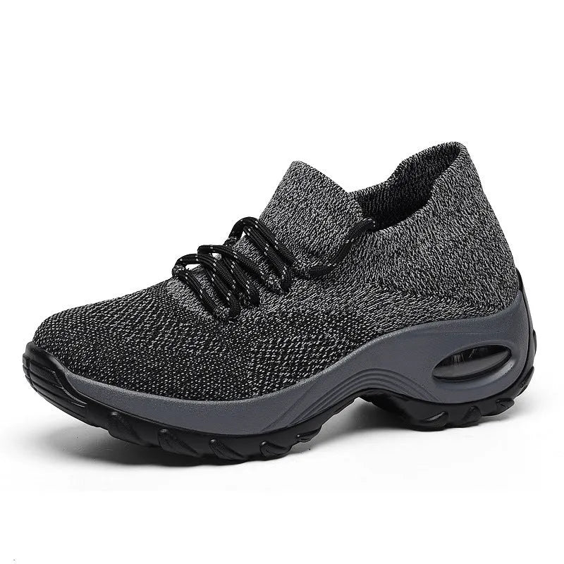 Women's flying knit platform sneakers in black with round toe and waterproof sole
