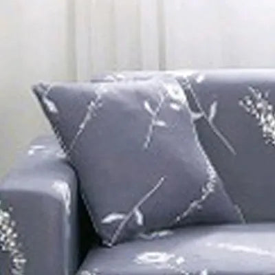 Geometric print polyester sofa slipcover stretched over sofa with matching pillowcase