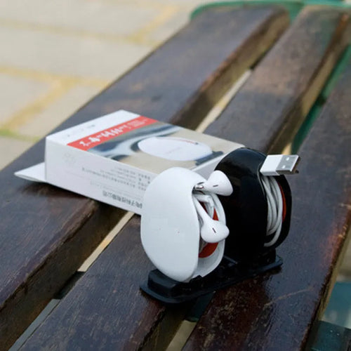 Automatic earphone retractor winder with telescopic reel and small storage box.