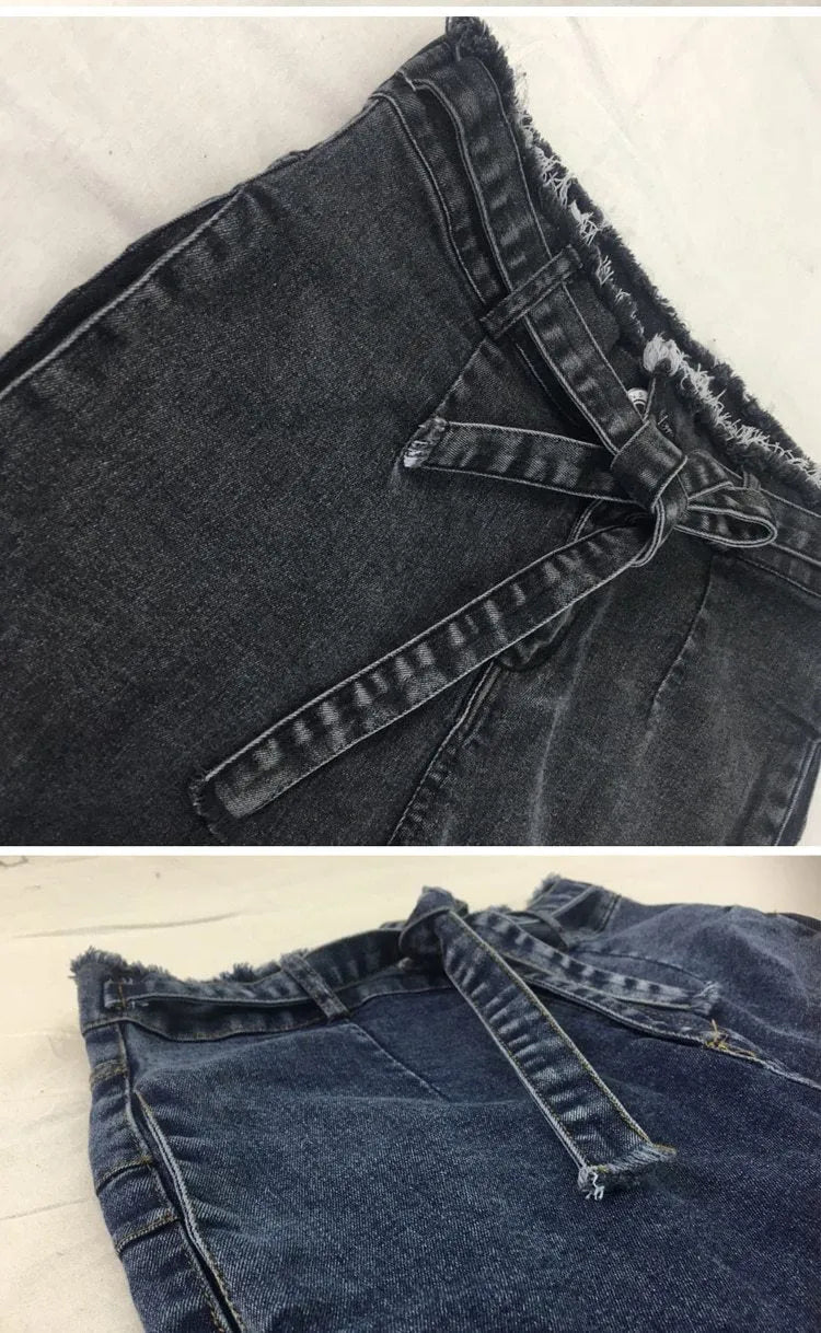 Pair of straight-leg jeans with a frayed fringed hem detail, shown in light blue denim.