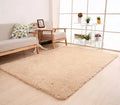 Solid colour plush area rug with non-slip dot-patterned bottom in rectangular shape