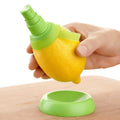Green plastic lemon sprayer juice dispenser with screw-in nozzle on a white background