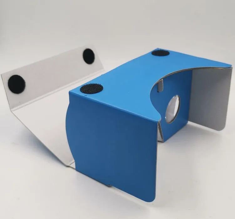 Foldable pink and white cardboard VR headset for smartphones with lenses and a head strap.