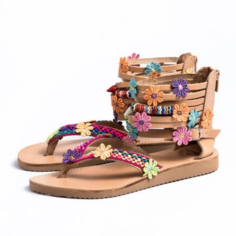 Ethnic beaded petal and flower decoration on artificial PU Roman sandals with a round toe.