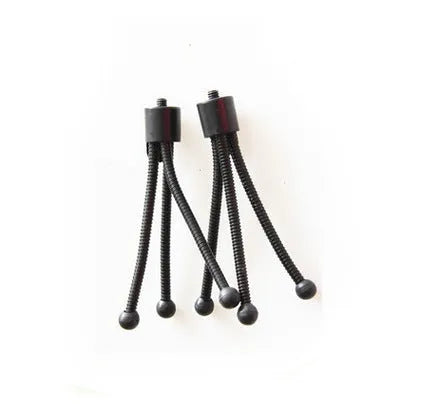 Small black iron mini tripod with ball head and folded legs on a table