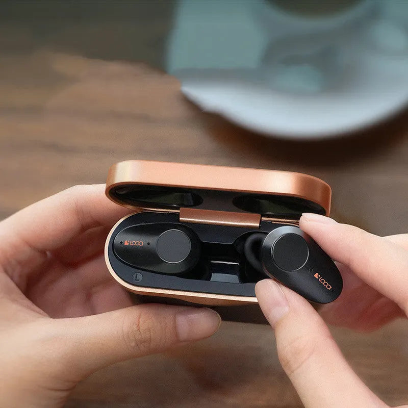 Black wireless Bluetooth headphones with charging stand showing Type-C and wireless charging options