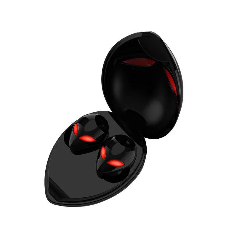 Creative Outer T8 Starman alien-design Bluetooth earbuds with red lighting next to wireless charging case.