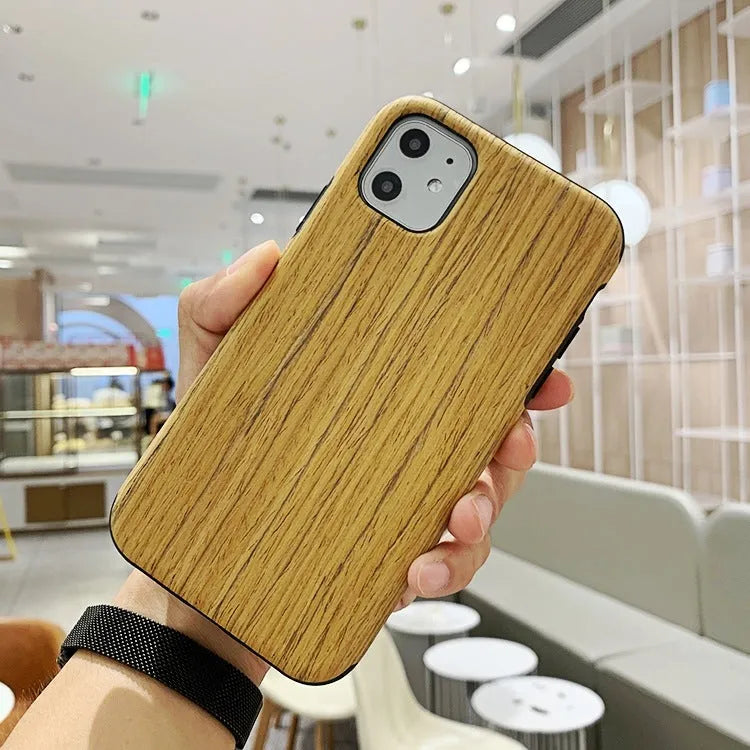 A slim wooden back cover case for an iPhone, showing the natural grain of rosewood or bamboo.