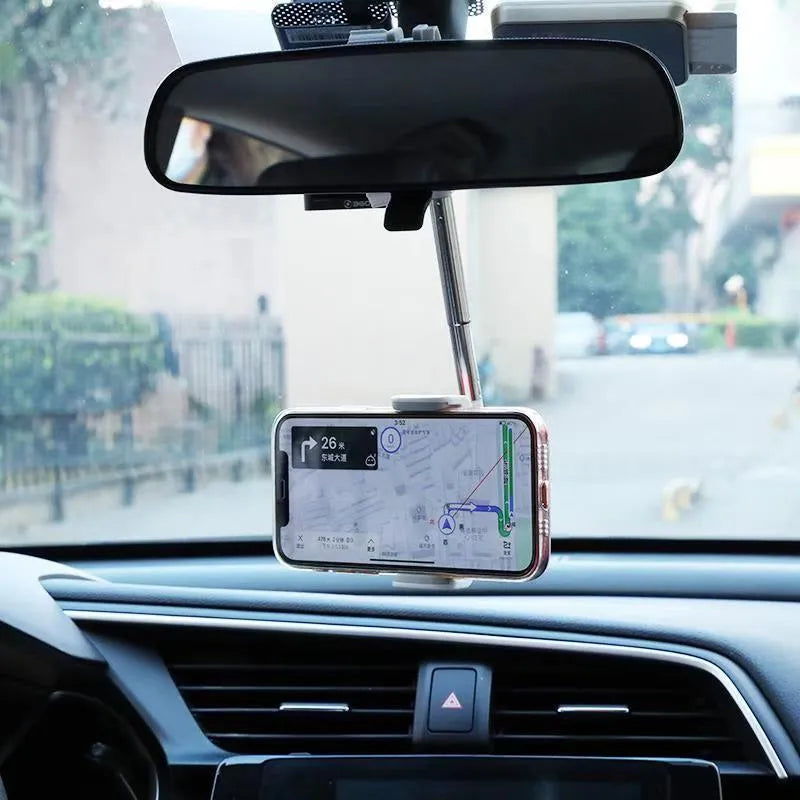 Black ABS plastic mobile phone bracket mounted on a car rearview mirror, holding a smartphone.