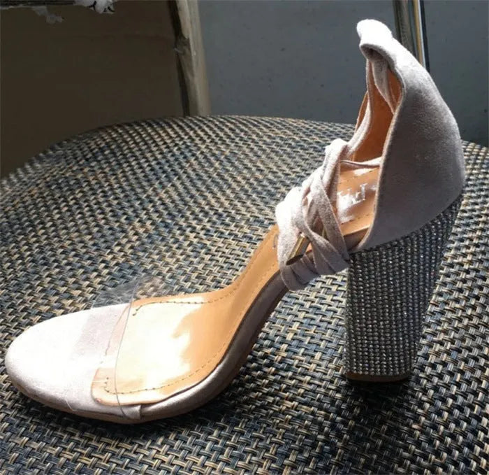 Women's black and gold pointed-toe plastic high heels showing front and side views