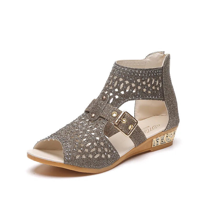 Women's beige flat sandals with a back zipper and low wedge heel on a white background.