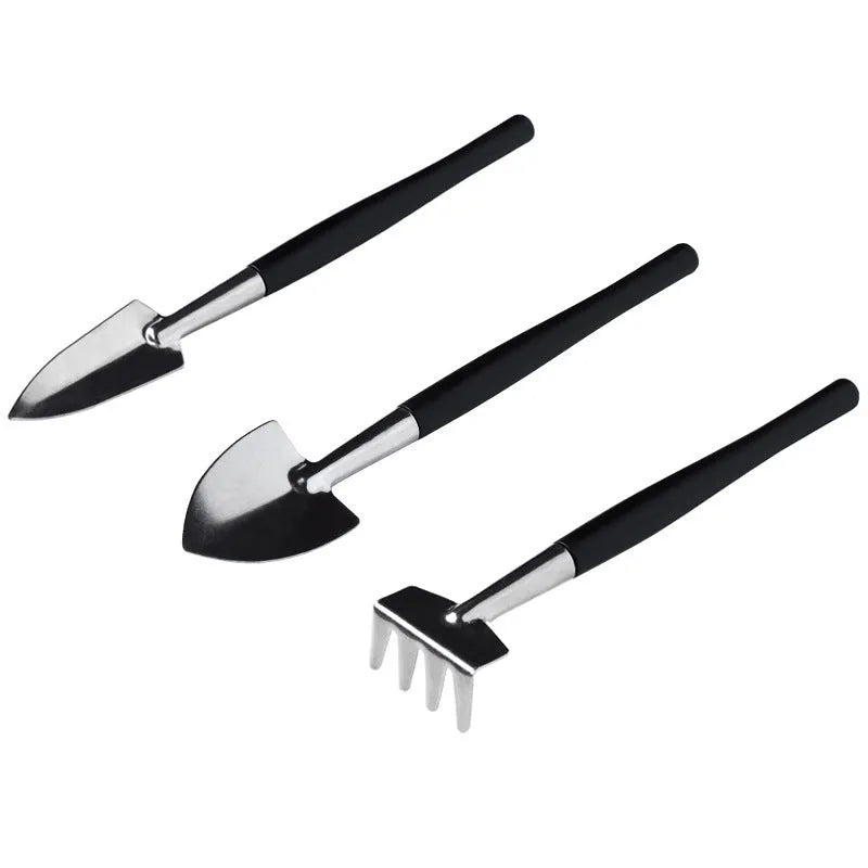Black plastic and metal mini succulent gardening tool set with 15 pieces laid out on a square cushion.