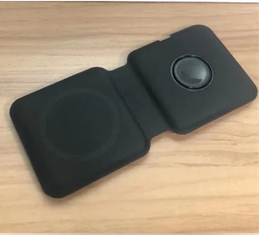 White foldable magnetic wireless charger charging two phones simultaneously on angled stand