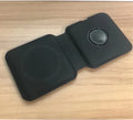White foldable magnetic wireless charger charging two phones simultaneously on angled stand
