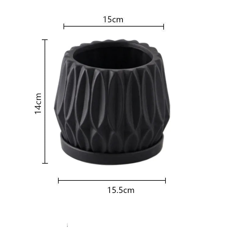 Grey small ceramic tabletop plant flowerpot on desktop with green plant
