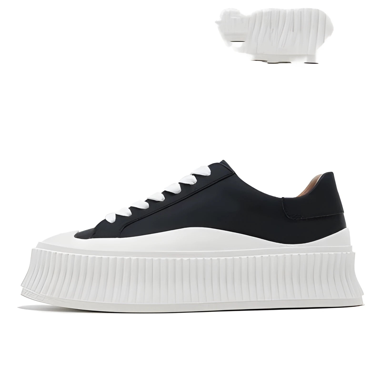 Women's black suede platform trainers with thick white soles and cross-lace design on a white background.