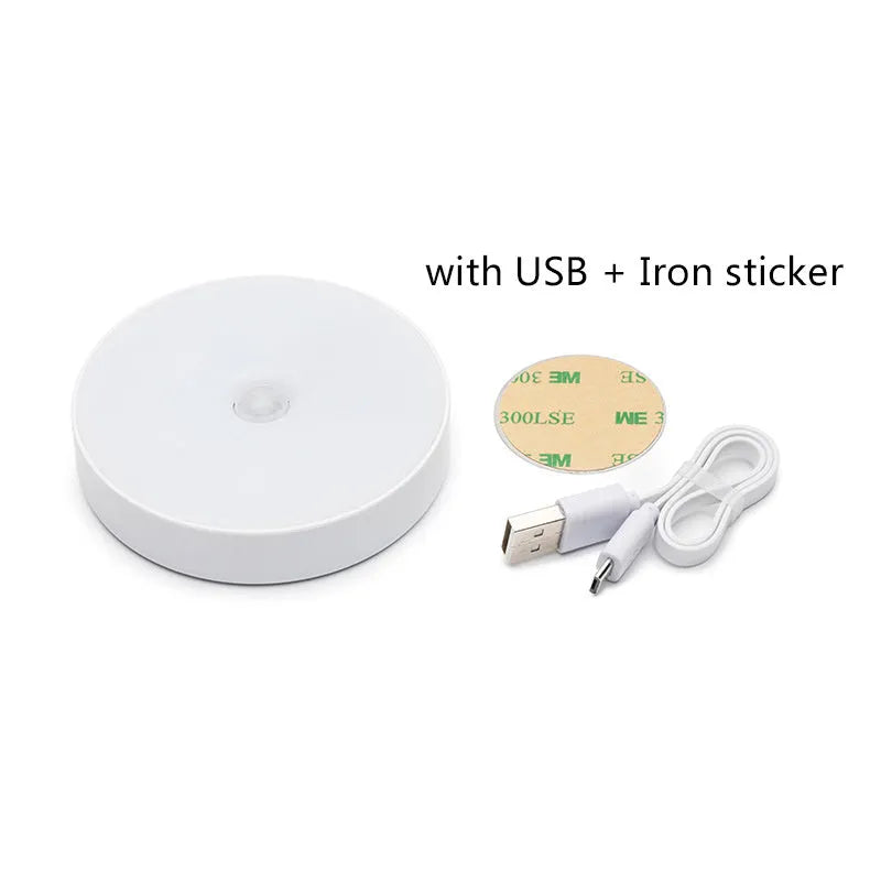 Compact round motion sensor LED night light with USB charging cable and adhesive mounting tape