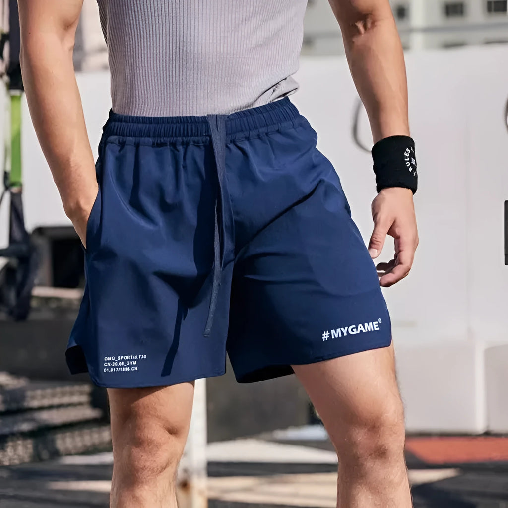 Men's grey fitness training shorts made from quick-drying polyester and spandex fabric.