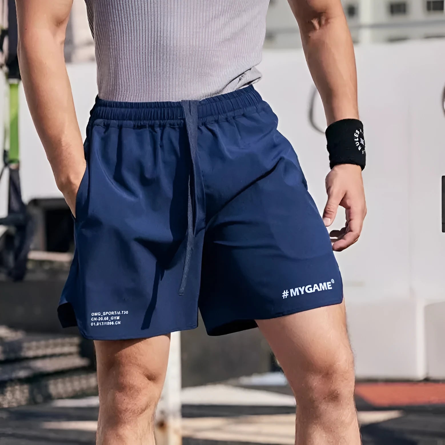 Men's grey fitness training shorts made from quick-drying polyester and spandex fabric.
