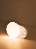 Baseus white rechargeable sensor night light with motion detection and USB charging port.