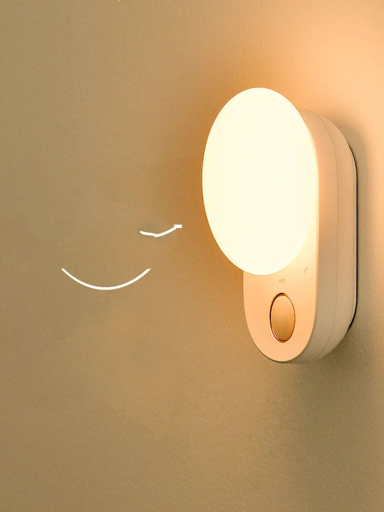 Baseus white rechargeable sensor night light with motion detection and USB charging port.