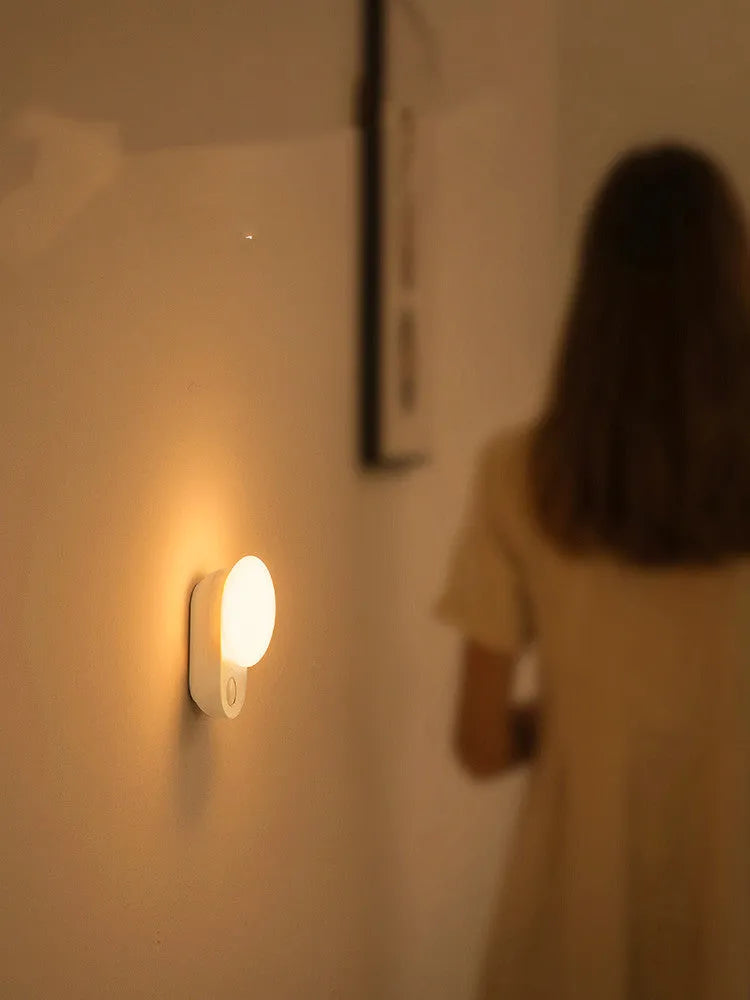Baseus white rechargeable sensor night light with motion detection and USB charging port.