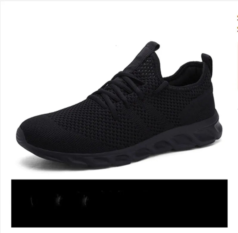 Men's black and white casual sneakers with breathable mesh upper and lace-up closure on a PVC sole.