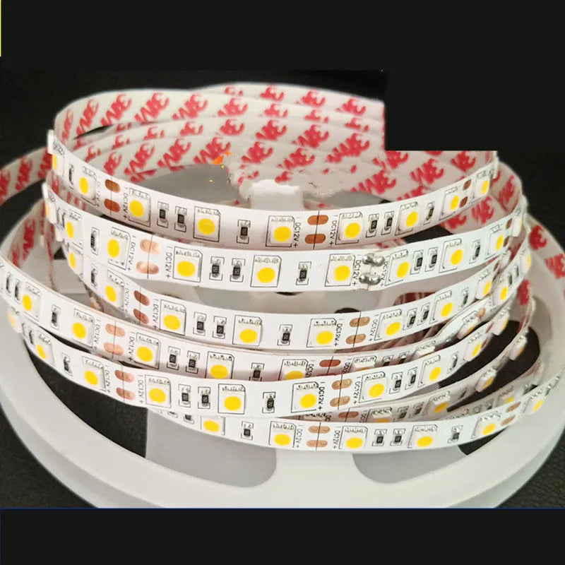 Close-up of a flexible 12V LED soft light strip with closely spaced white LEDs, showing solder connection patches.